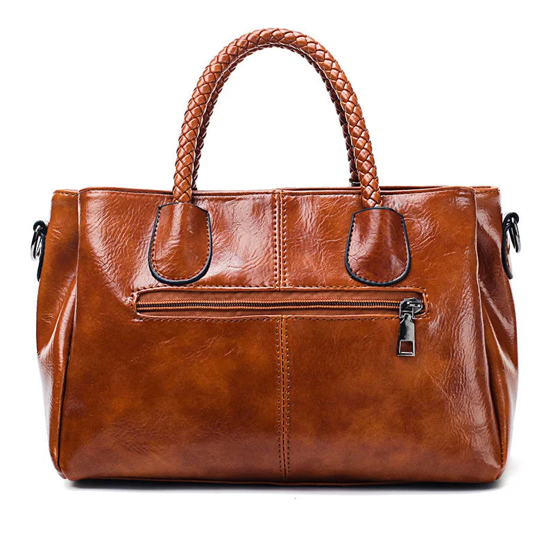 Pia | "Elegant leather handbag with braided handle".